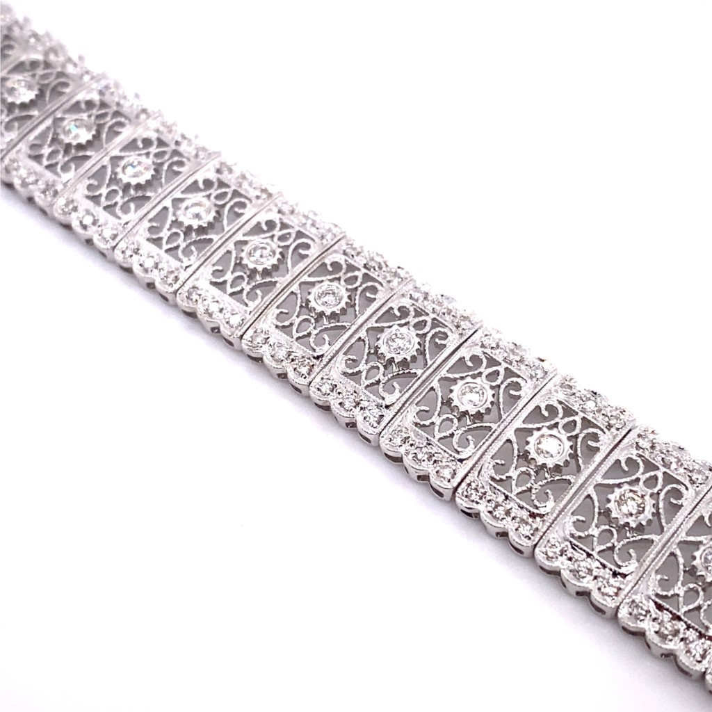 a silver bracelet with filigrees and diamonds