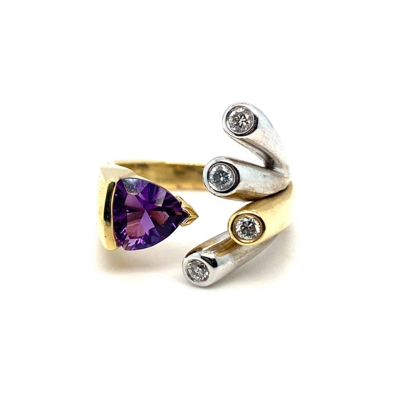 a gold ring with a purple stone and two diamonds