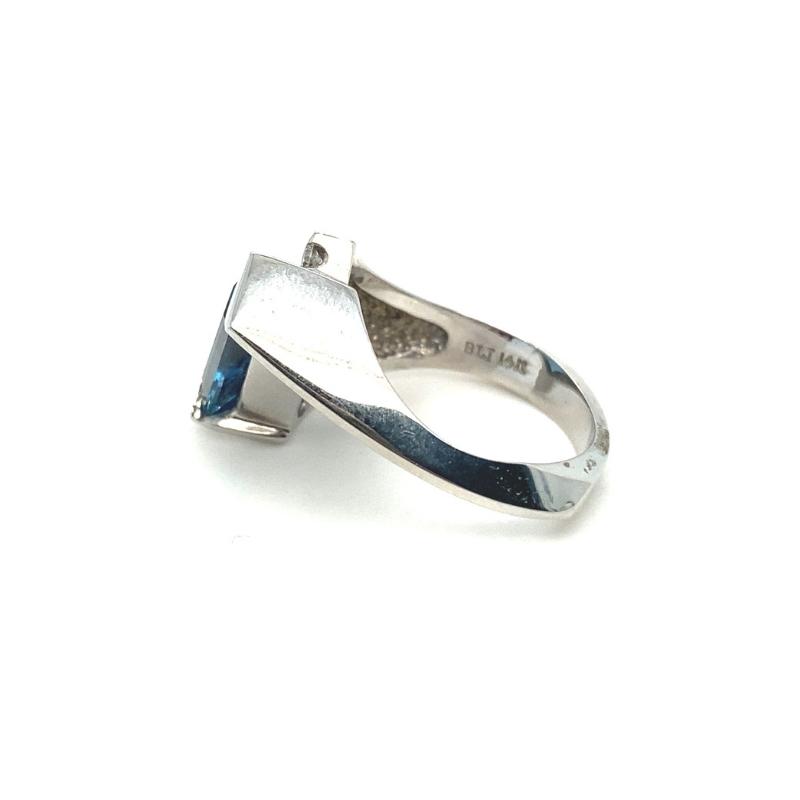 a silver ring with a blue stone on it