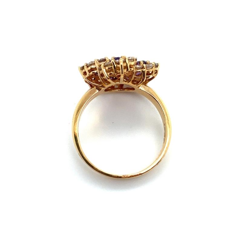 a gold ring with three stones on top