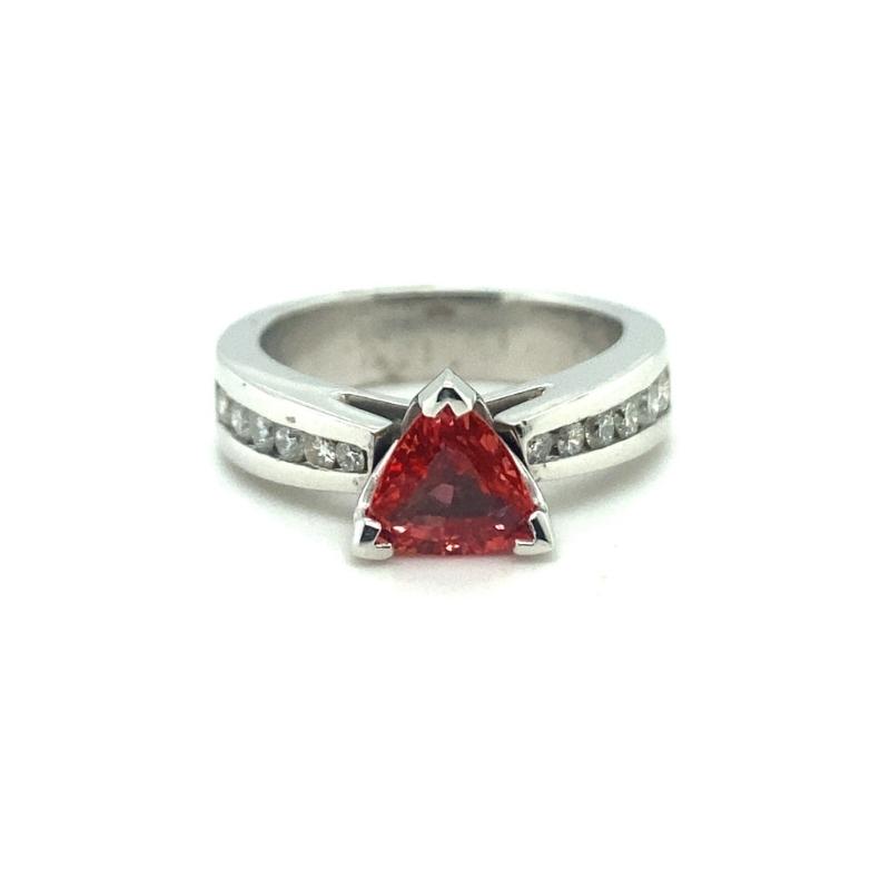 a red triangle shaped ring with diamonds on it