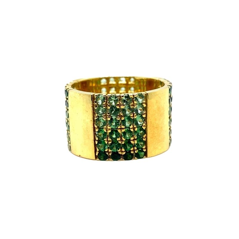 a gold ring with green beads on it