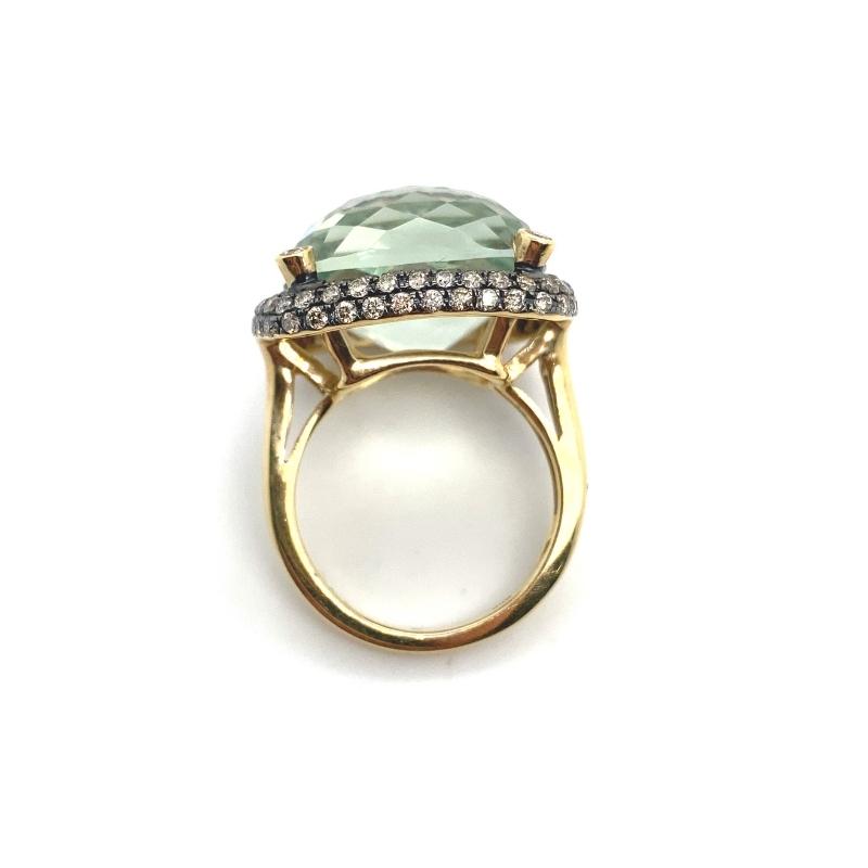 a ring with an aqua green stone and diamonds