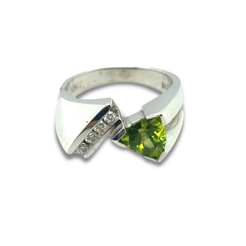 a silver ring with a green stone in the middle