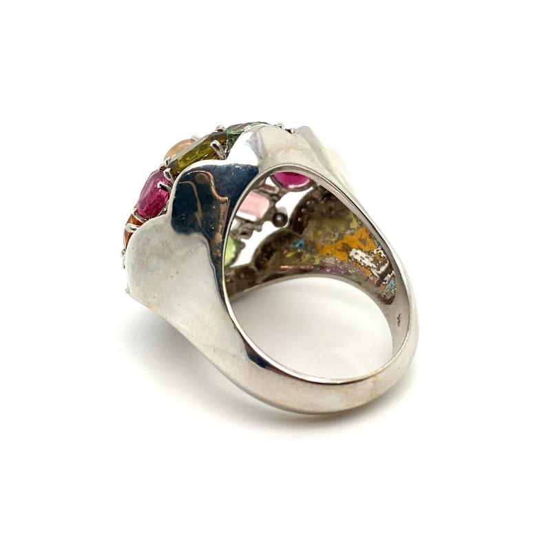 a silver ring with multicolored stones on it