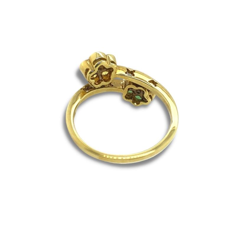 a gold ring with two flowers on it