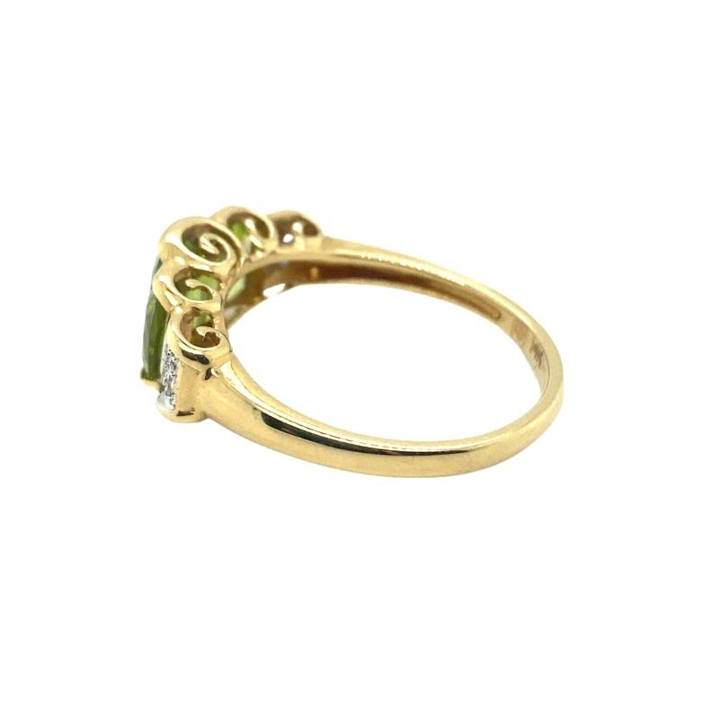 a yellow gold ring with an emerald stone