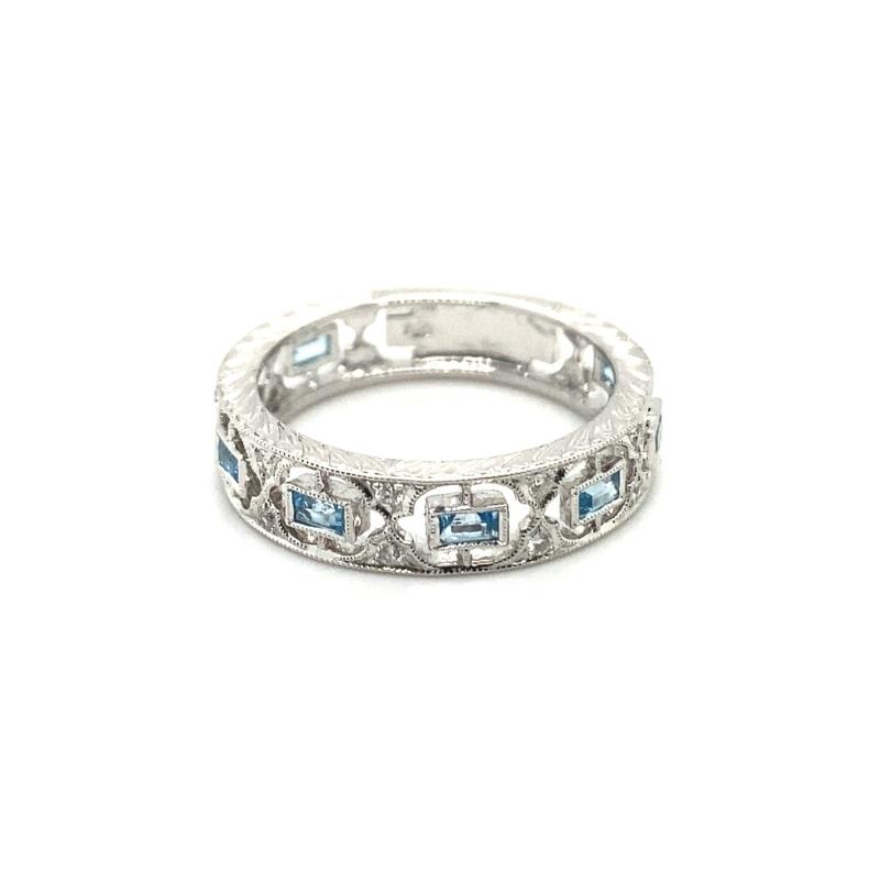 a white gold ring with blue stones