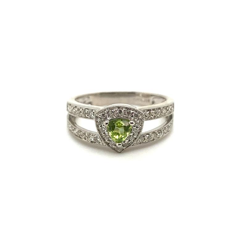 a white gold ring with a heart shaped green stone