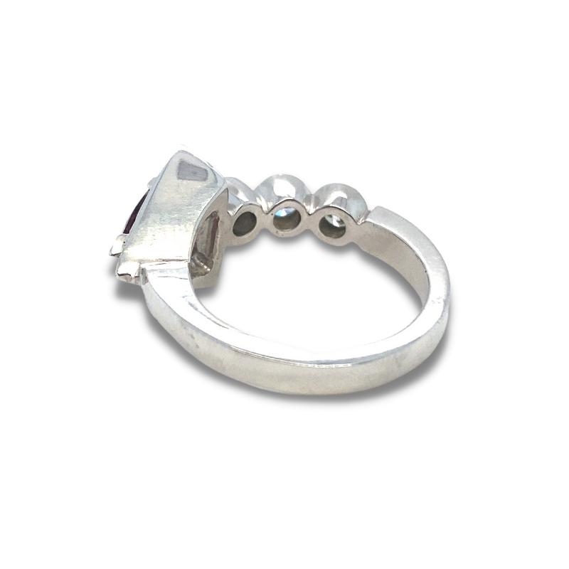 a silver ring with three balls on it