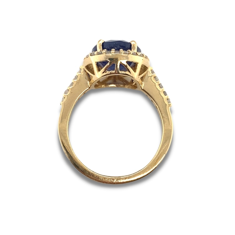 a yellow gold ring with an oval blue sapphire