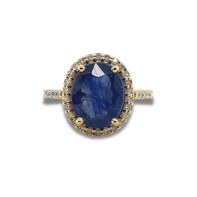 an oval blue stone ring with two tone gold accents