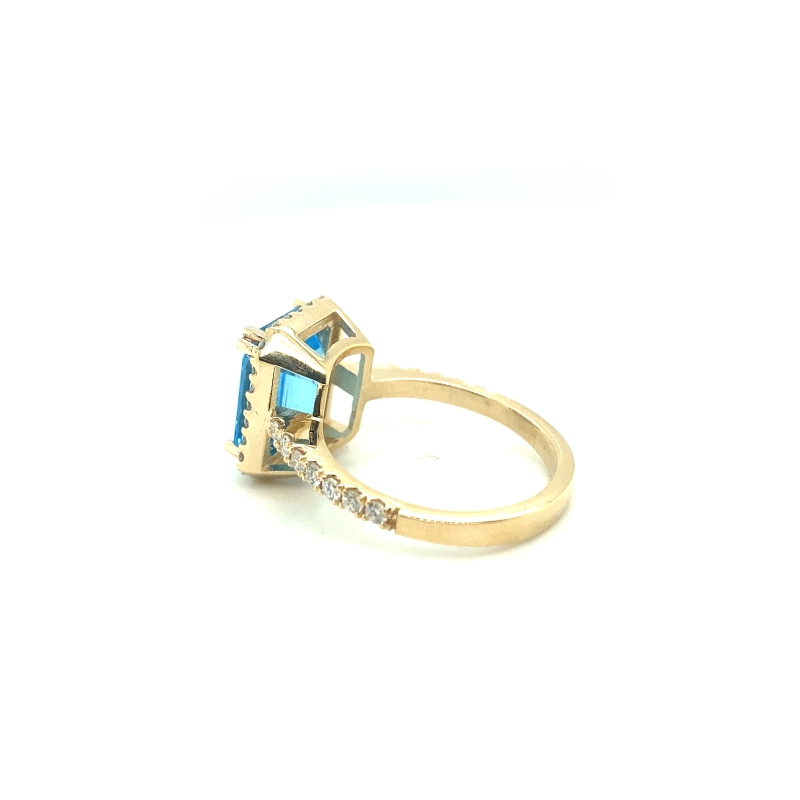 a diamond and blue topaz ring on a white background