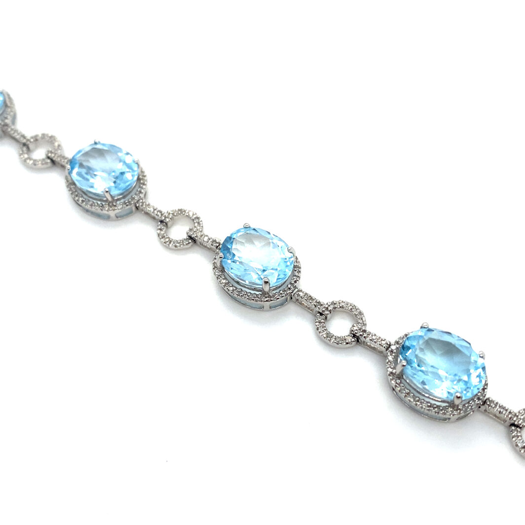 a bracelet with blue stones and diamonds