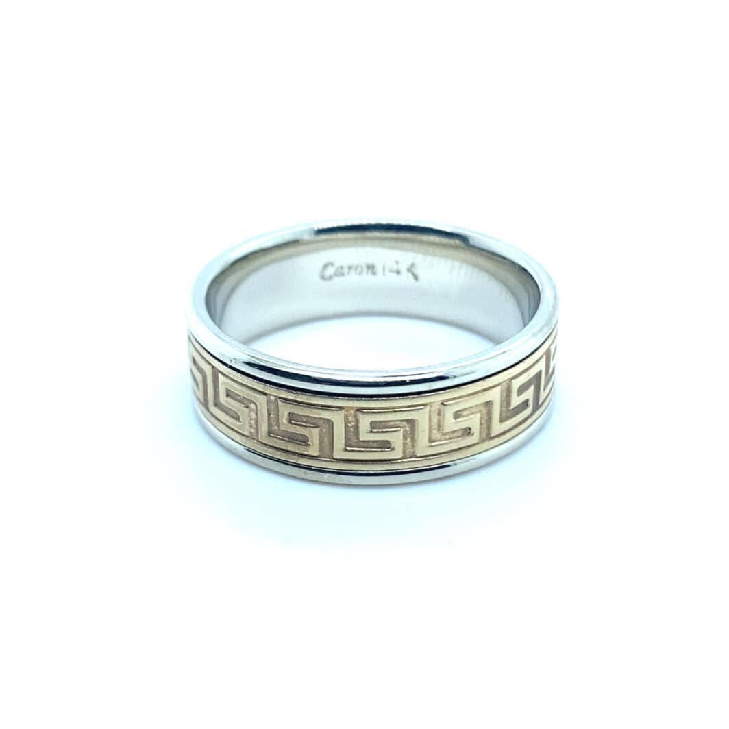 a silver ring with greek writing on it