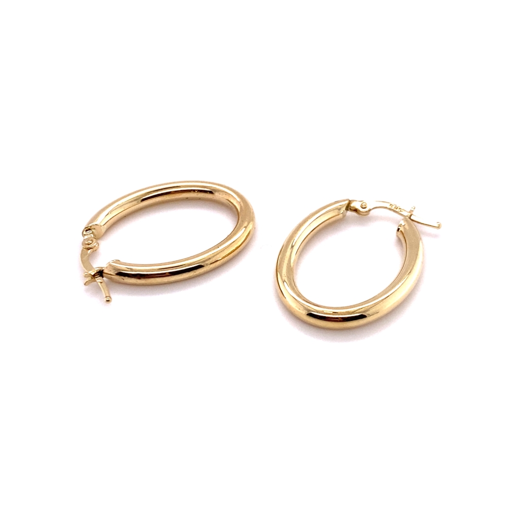 two pairs of gold hoop earrings on a white background