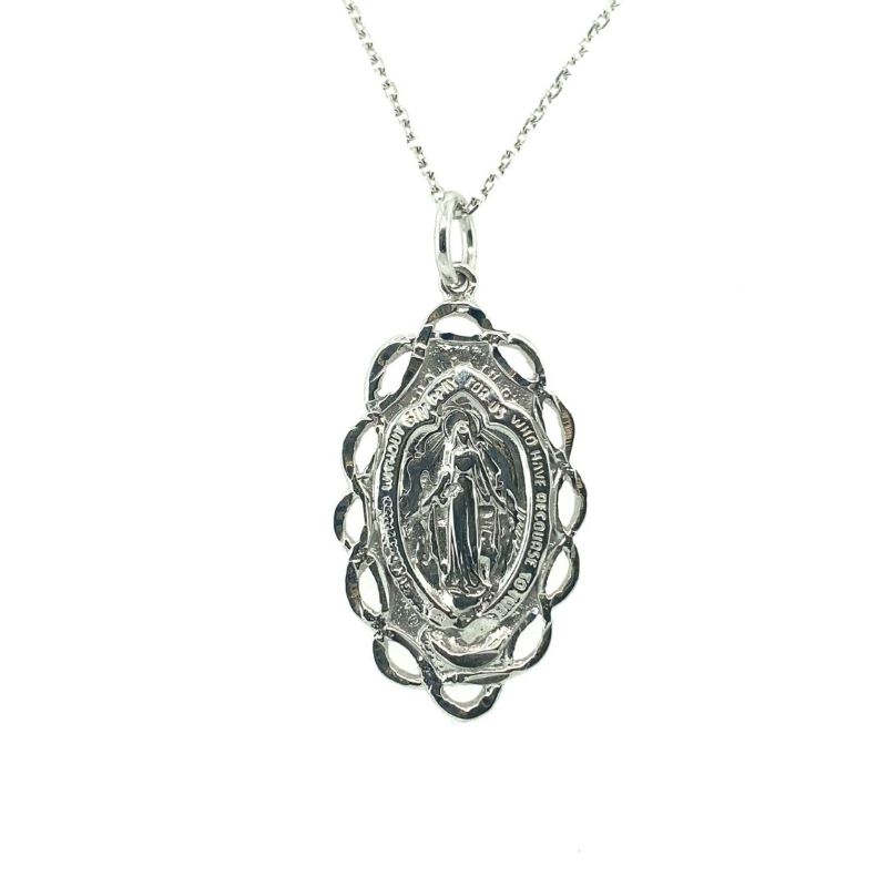 a silver pendant with an image of jesus on it