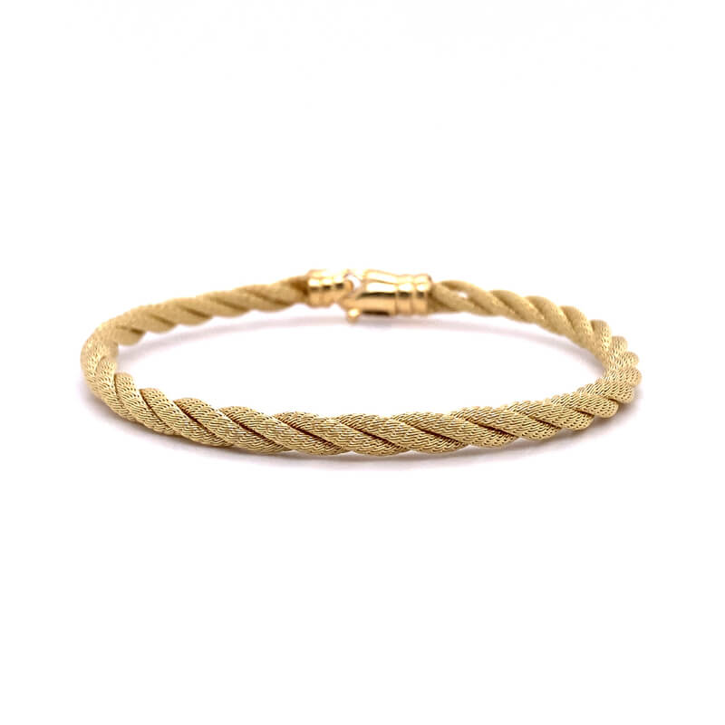 a gold braid bracelet on a white background