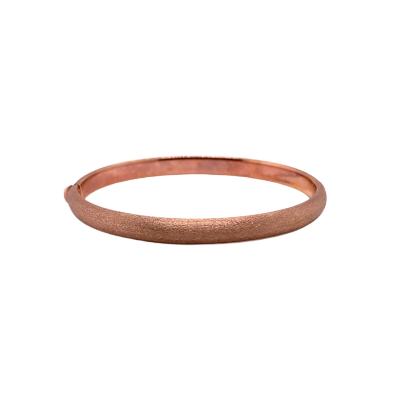 a thin rose gold ring on a white background