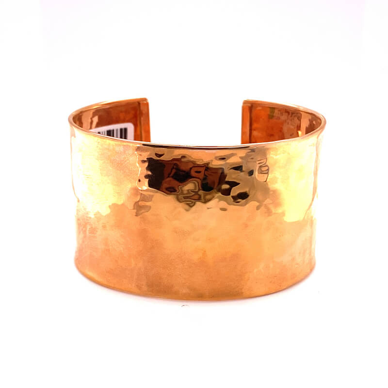 a close up of a gold cuff on a white background