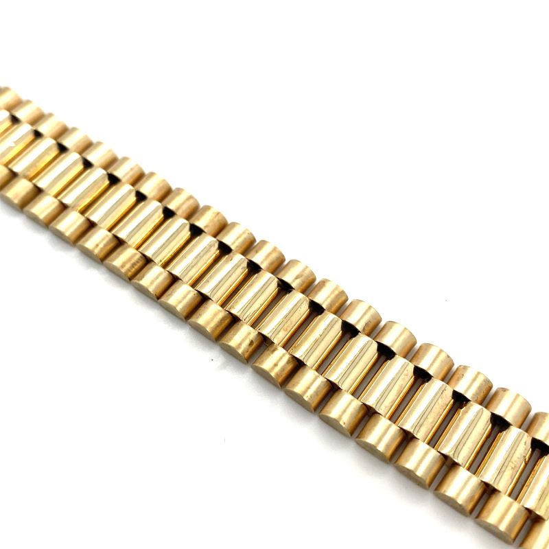 a gold watch bracelet on a white background