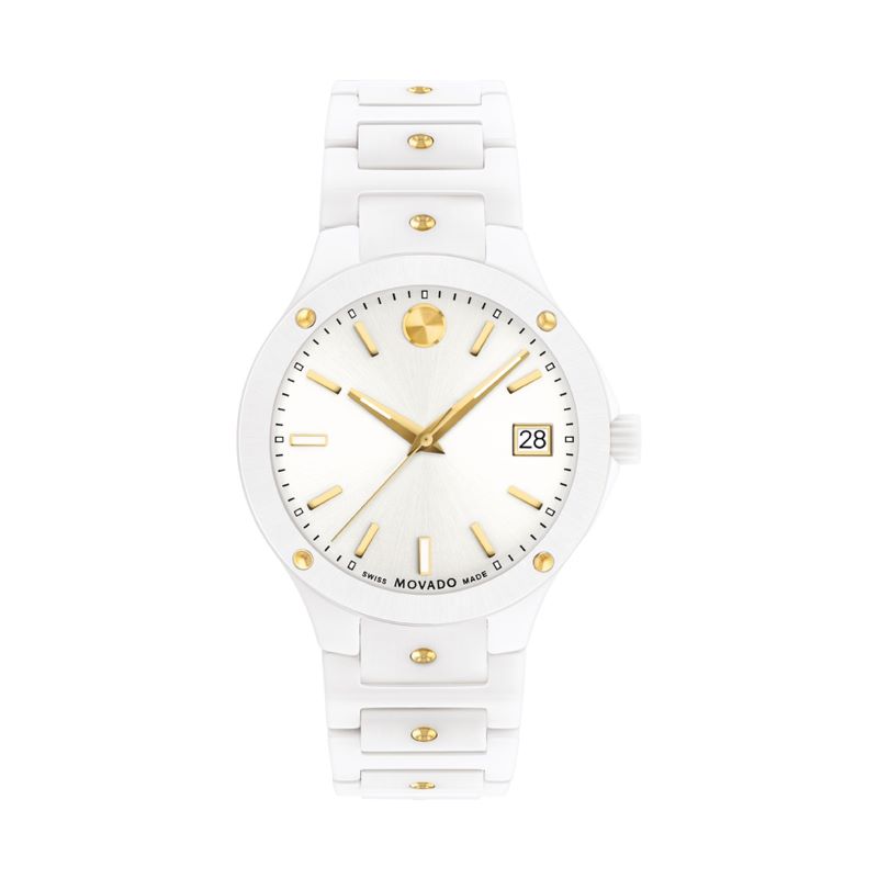 a white watch with gold accents on the face