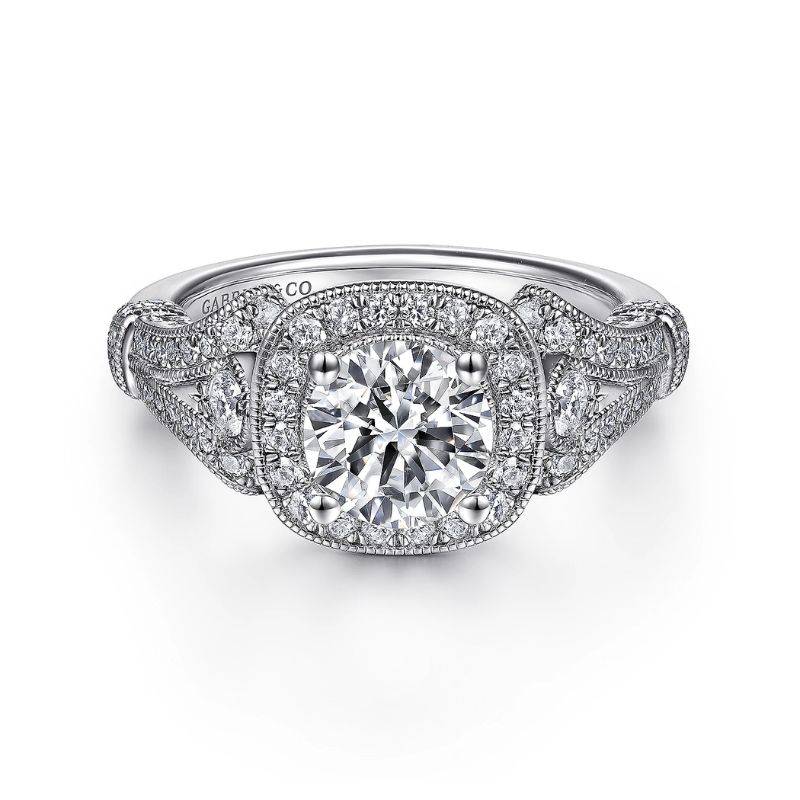 a white gold engagement ring with an intricate halo setting