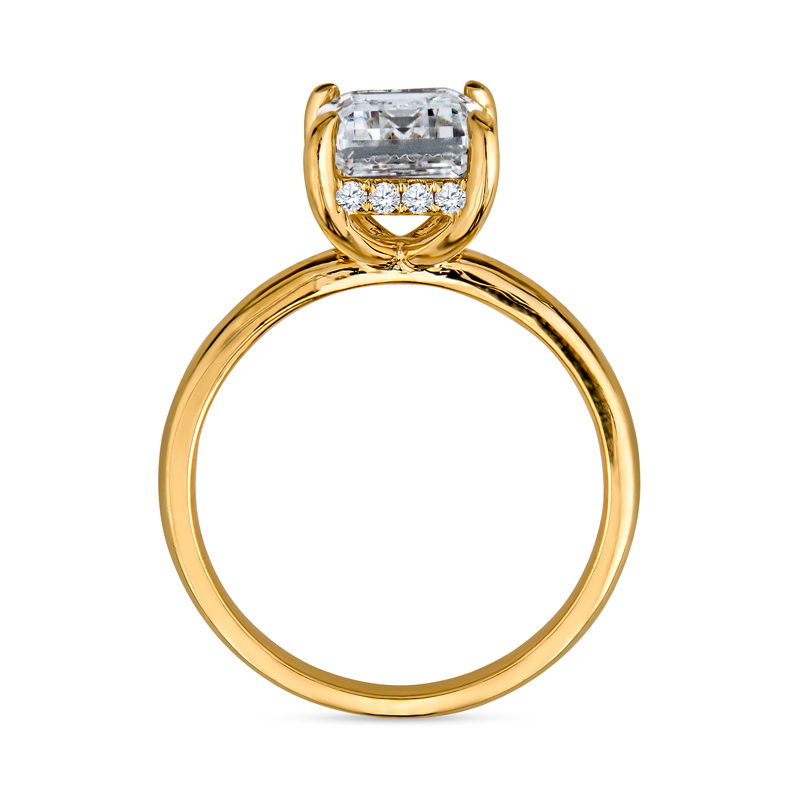 a yellow gold ring with a square cut diamond