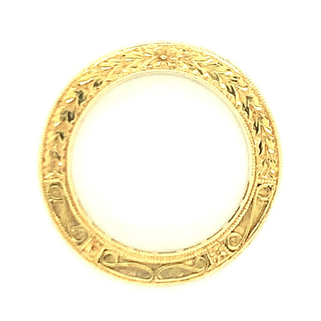 a gold ring with intricate designs on it