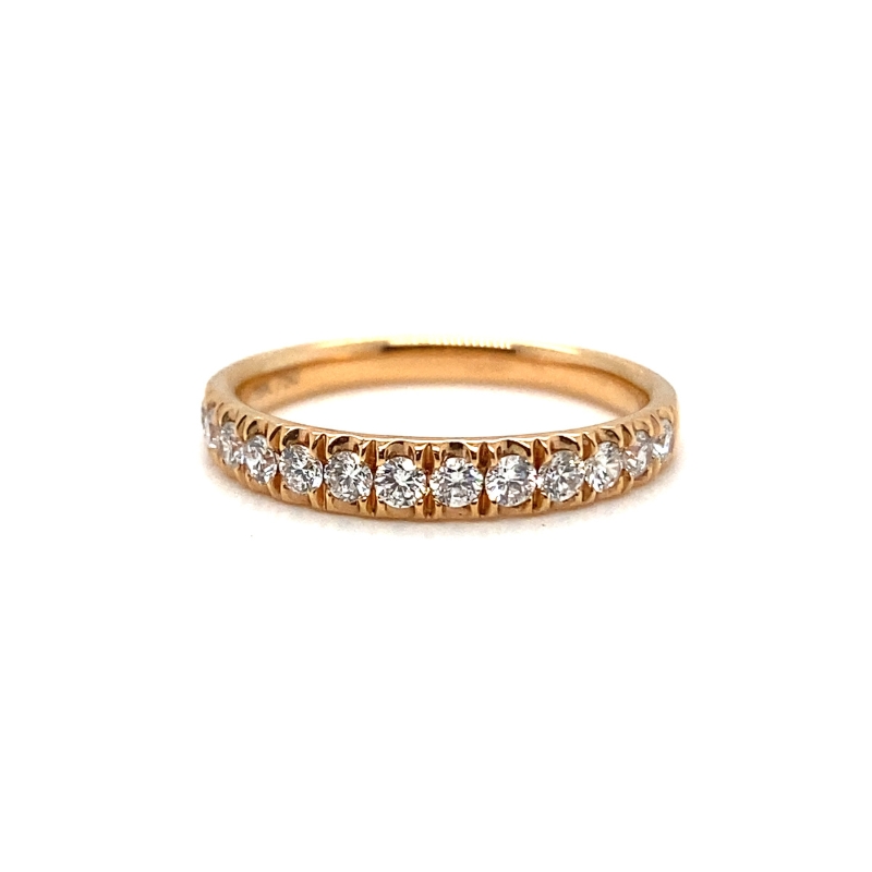 a gold ring with five diamonds on it