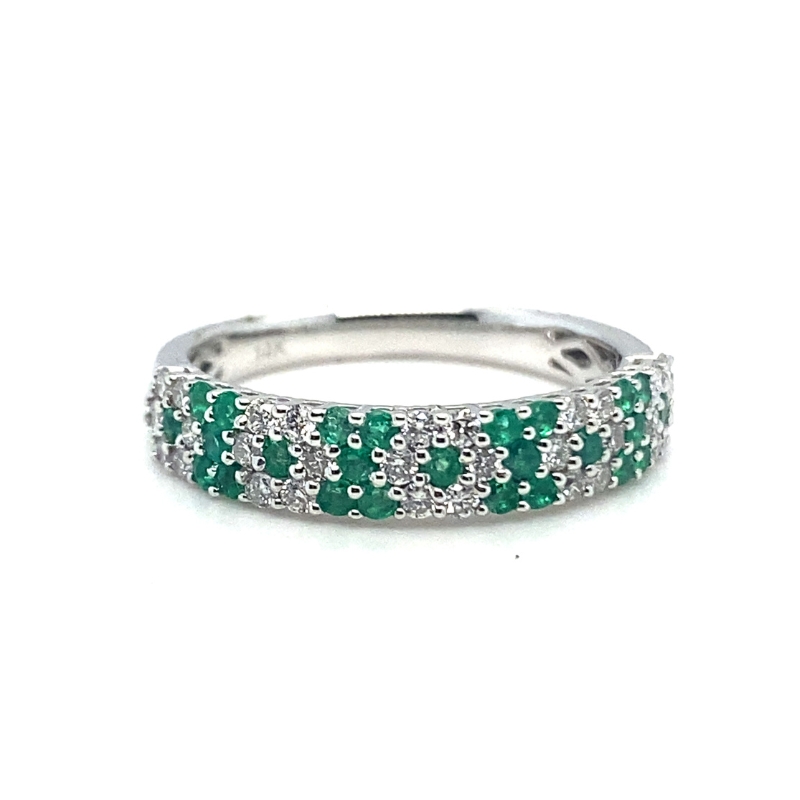 a white gold ring with green and white stones