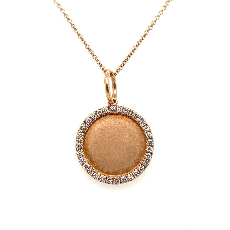 a gold pendant with diamonds on it
