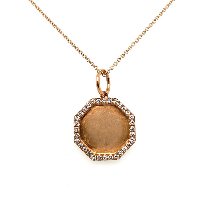 a gold necklace with a brown stone and white diamonds