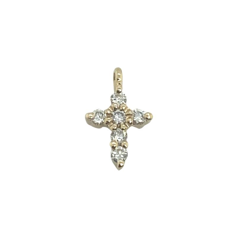 a cross charm with three stones on it
