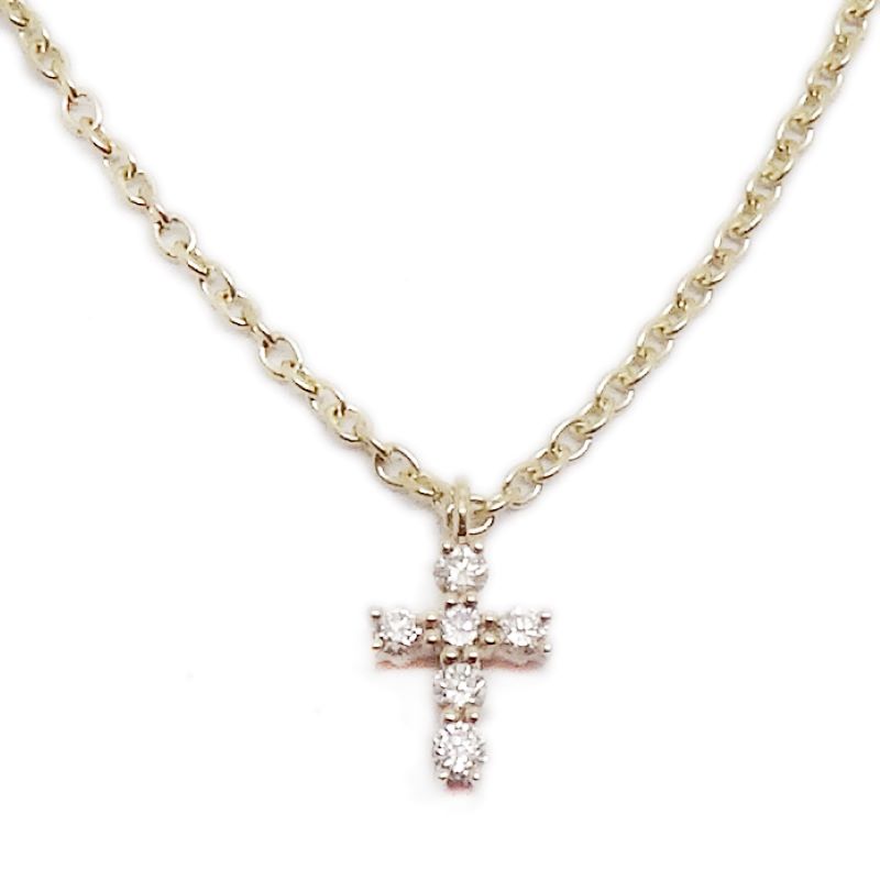 a gold cross necklace with two diamonds on it