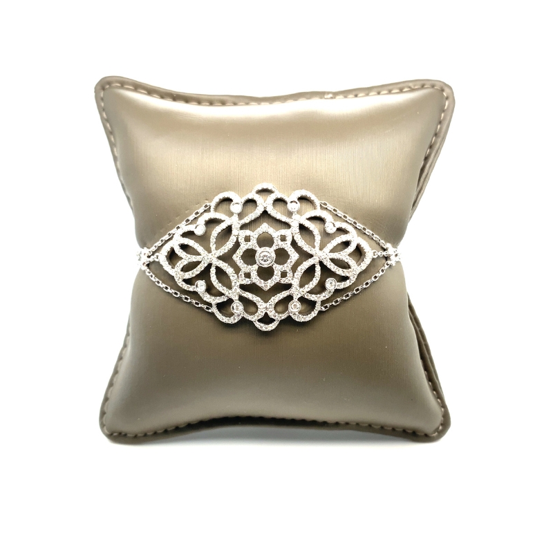 a silver pillow with a ring on it