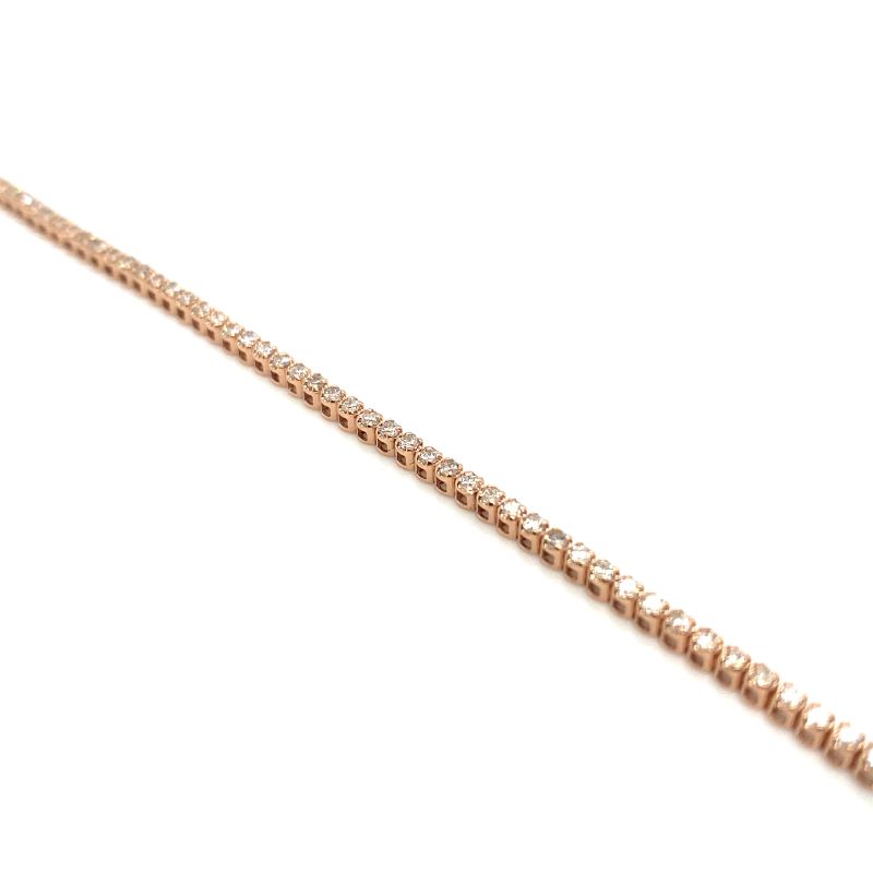 a gold chain that is on a white surface