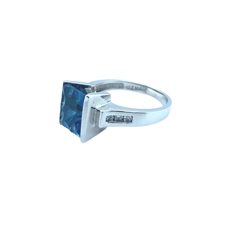 a ring with a blue stone on it