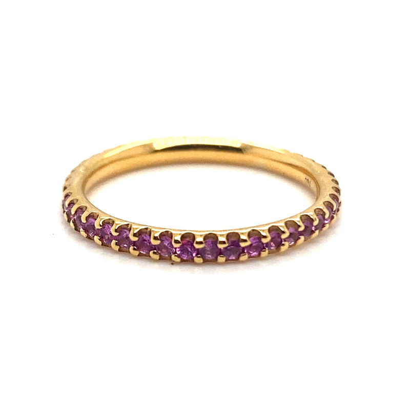 a yellow gold band with purple stones