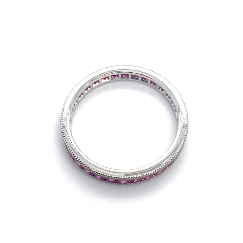 a white gold ring with pink sapphire stones