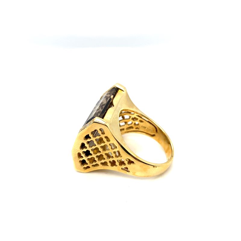 a gold ring with a black and white design