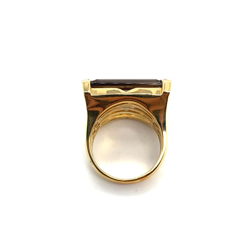 a gold ring with a brown stone on it