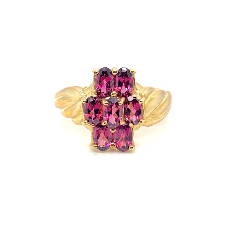 a ring with pink stones and leaves on it