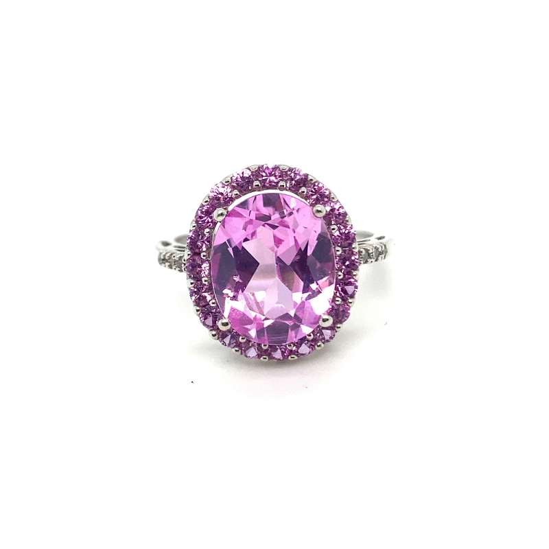 a pink ring with purple stones on it