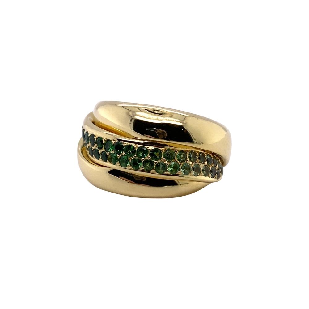 a gold ring with green and white stones