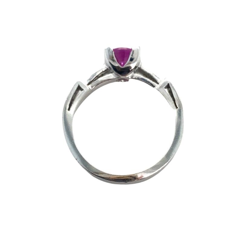 a silver ring with a pink stone in the center