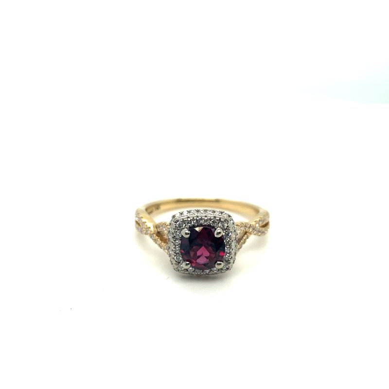 a gold ring with a purple stone surrounded by diamonds