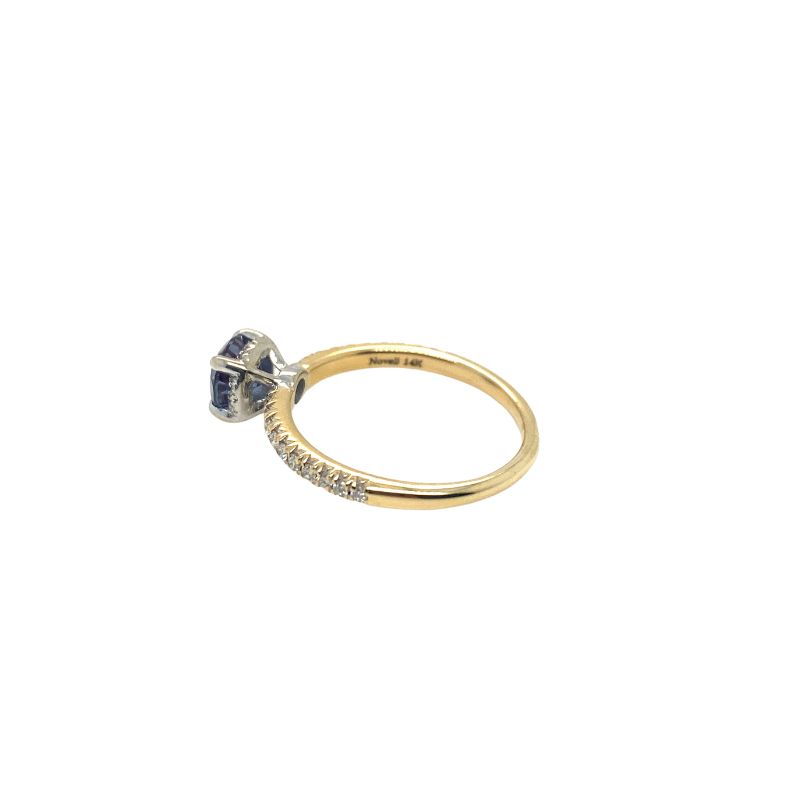 a yellow gold ring with a blue and white diamond