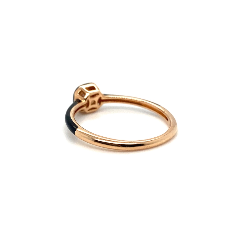 a gold and black ring with a bow on it