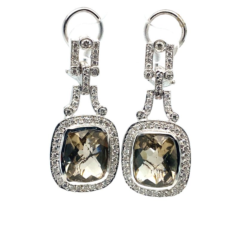 a pair of earrings with an amethorate and diamonds